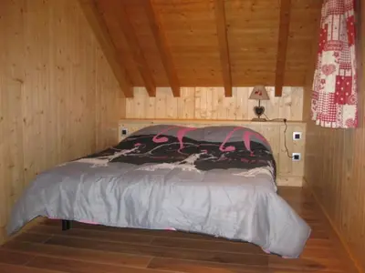 a bedroom with a bed in a wooden room at Appartement Léa in Chamonix-Mont-Blanc
