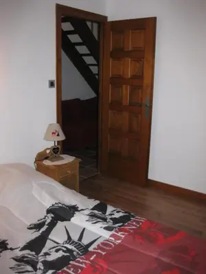 a bedroom with a bed and a door and a lamp at Appartement Léa in Chamonix-Mont-Blanc
