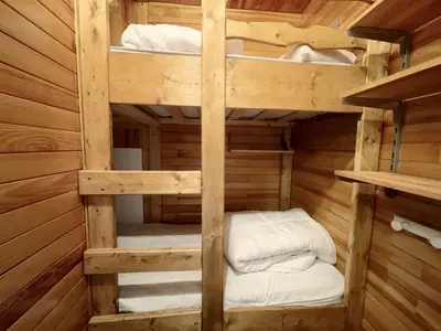 a bunk bed in a wooden cabin at 3 PIECES résidence LA POINTE PERCEE - FR-1-572-207 in Arâches-la-Frasse