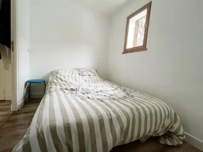 a bed in a white room with a window at 3 PIECES résidence LA POINTE PERCEE - FR-1-572-207 in Arâches-la-Frasse