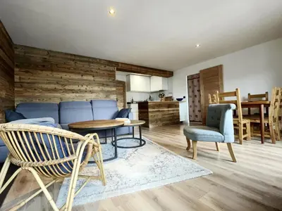 a living room with a blue couch and a table and chairs at 3 PIECES résidence LA POINTE PERCEE - FR-1-572-207 in Arâches-la-Frasse