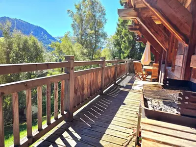 a wooden deck on a cabin with a view at Chalet near centre of Megève in Megève