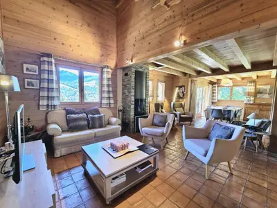 a living room with a couch and chairs and a table at Chalet near centre of Megève in Megève