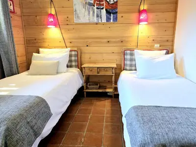 two beds sitting next to each other in a room at Chalet near centre of Megève in Megève