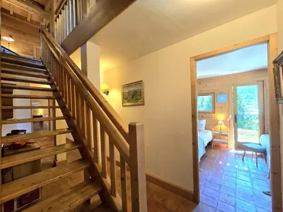 a staircase in a room with a bedroom at Chalet near centre of Megève in Megève