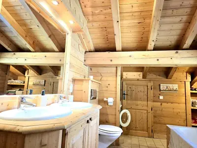 a bathroom with two sinks and a toilet in a cabin at Chalet near centre of Megève in Megève