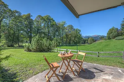 a table and two chairs sitting on a patio at Appartement Pruniers - Welkeys in Megève