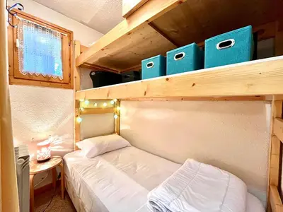 a small bedroom with a bunk bed in a tiny house at Bright apartment with Mont Blanc view in Combloux