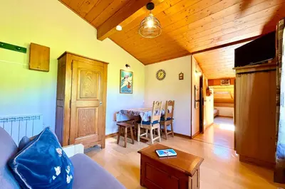 a living room with a couch and a table at Le Grenier du Feug in Combloux