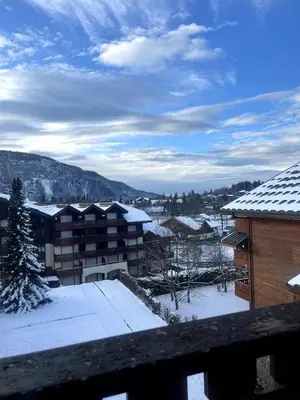 a view of a snow covered city with buildings at Appartement au centre des Carroz in Arâches-la-Frasse