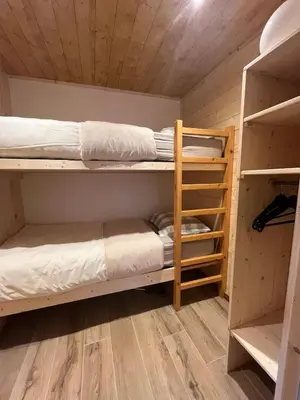 a bunk bed room with two bunk beds in it at Appartement au centre des Carroz in Arâches-la-Frasse