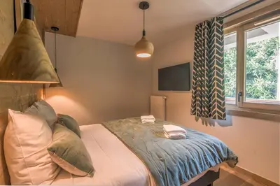 a bedroom with a bed with two towels on it at Appartement Havre des Alpes - Welkeys in Megève