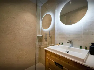 a bathroom with a sink and a mirror at Chalet RevAlp - OVO Network in Combloux