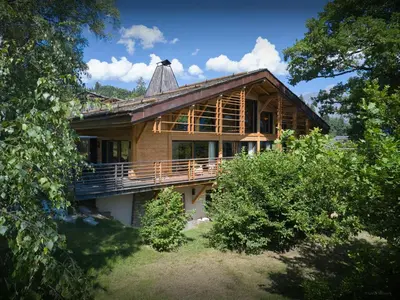 a large wooden house with a gambrel roof at Chalet RevAlp - OVO Network in Combloux