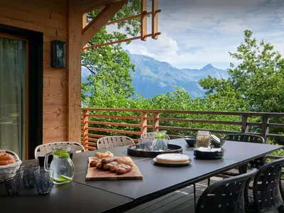 a black table with food on it on a balcony at Chalet RevAlp - OVO Network in Combloux