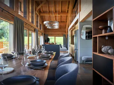 a dining room with a long table and chairs at Chalet RevAlp - OVO Network in Combloux