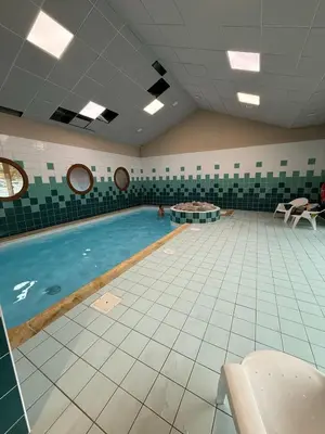 a large indoor swimming pool in a building at Appartement Samoens Cosy in Samoëns