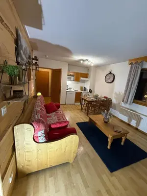 a living room with a couch and a table at Appartement Samoens Cosy in Samoëns