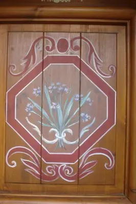 a wooden door with a flower painted on it at gîte 6 pers RC domaine skiable Grand Massif les Carroz Flaine Morillon Samoens in Les Carroz d'Araches