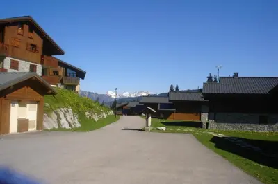 an empty road in a village with buildings at gîte 6 pers RC domaine skiable Grand Massif les Carroz Flaine Morillon Samoens in Les Carroz d'Araches