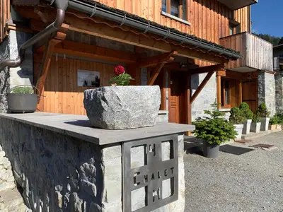 a bedroom with a large bed with red pillows at Chalet 4M Les Carroz et son Spa in Les Carroz d'Araches