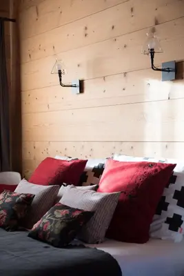 a group of pillows sitting on a bed at Chalet 4M Les Carroz et son Spa in Les Carroz d'Araches