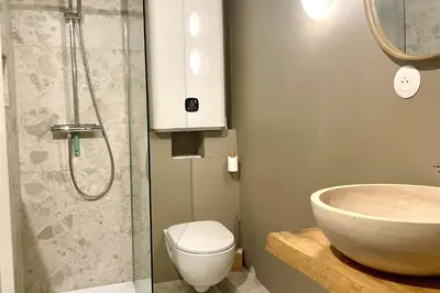 a bathroom with a sink and a toilet and a shower at Appartement Rosset - Welkeys in Megève