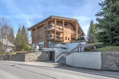 a house on the side of a road at Appartement Rosset - Welkeys in Megève