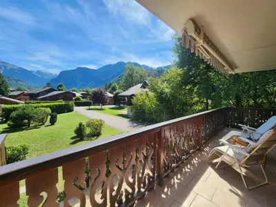a balcony with a view of a yard at T3 calme à Samoëns, proche centre, WIFI, parking privé - FR-1-629-150 in Samoëns