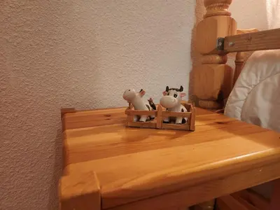 two stuffed animals sitting on top of a wooden table at T3 calme à Samoëns, proche centre, WIFI, parking privé - FR-1-629-150 in Samoëns