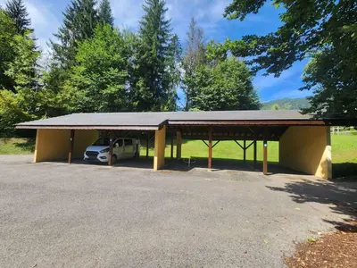 a parking lot with a car parked under a roof at T3 calme à Samoëns, proche centre, WIFI, parking privé - FR-1-629-150 in Samoëns