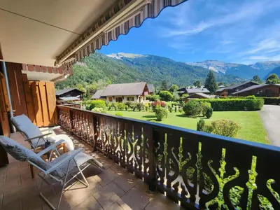 a balcony with two chairs and a view of a yard at T3 calme à Samoëns, proche centre, WIFI, parking privé - FR-1-629-150 in Samoëns