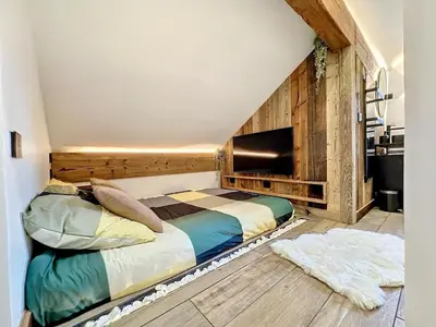 a bedroom with a bed in a room at Modern 2BR Apt with Mountain Views & Private Parking in Les Houches