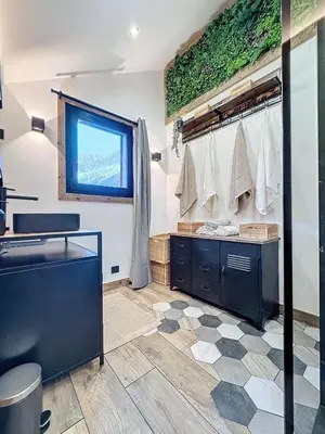 a bathroom with a sink and a mirror at Modern 2BR Apt with Mountain Views & Private Parking in Les Houches