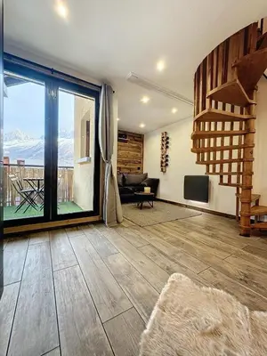 a living room with a large window and a couch at Modern 2BR Apt with Mountain Views & Private Parking in Les Houches