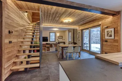a house with wooden walls and a spiral staircase at Luxurious Chalet Verney - 8 people in Chamonix-Mont-Blanc