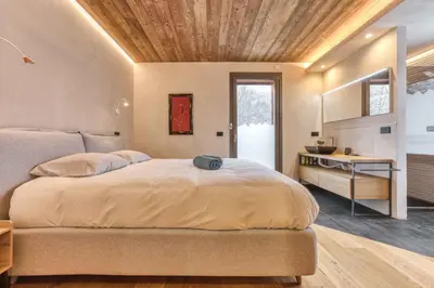 a bedroom with a large bed with a wooden ceiling at Luxurious Chalet Verney - 8 people in Chamonix-Mont-Blanc