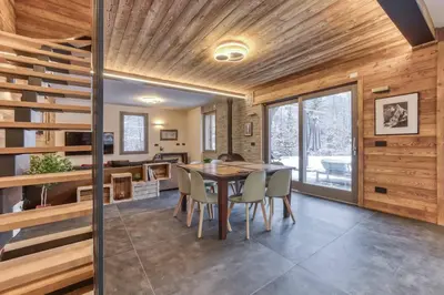a kitchen and dining room with a table and chairs at Luxurious Chalet Verney - 8 people in Chamonix-Mont-Blanc