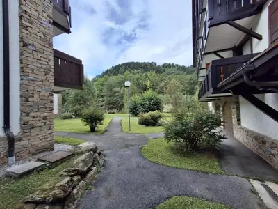 a walkway between two buildings in a yard at Les Contamines Montjoie in Le Cugnon
