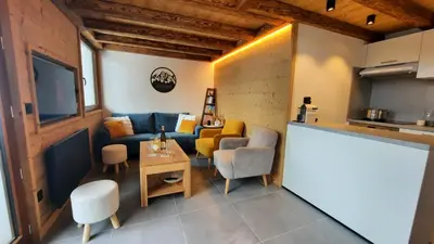 a living room with a couch and a table at NEW - Le Splendid' - Duplex standing rénové 6-8 pers in Arâches-la-Frasse