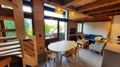 a room with a table and chairs and a couch at NEW - Le Splendid' - Duplex standing rénové 6-8 pers in Arâches-la-Frasse