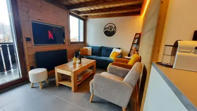 a living room with a couch and a table at NEW - Le Splendid' - Duplex standing rénové 6-8 pers in Arâches-la-Frasse