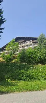 a large building in the middle of a field of grass at AP-37 La Grande Cordée Combloux in Combloux