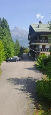 a car parked in a parking lot next to a building at AP-37 La Grande Cordée Combloux in Combloux