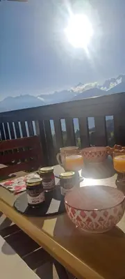 a table with bowls and containers on a balcony at AP-37 La Grande Cordée Combloux in Combloux