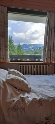 a bed in a room with a large window at AP-37 La Grande Cordée Combloux in Combloux