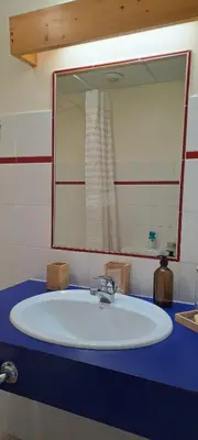 a bathroom with a sink and a large mirror at AP-37 La Grande Cordée Combloux in Combloux