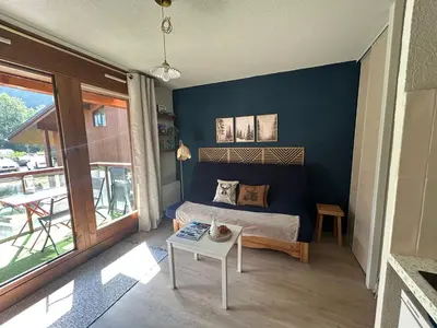 a bedroom with a bed and a table in a room at Petit appartement cosy in Les Contamines-Montjoie