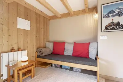 a room with a bench in the corner of a room at Le Mont Joux - Vue montagne in Saint-Gervais-les-Bains