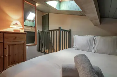 a bedroom with a large white bed and a window at Le Mont Joux - Vue montagne in Saint-Gervais-les-Bains
